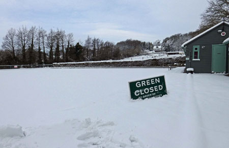 picture of deep snow on green, with closed sign.