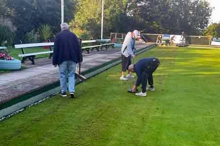 picture of men working on green